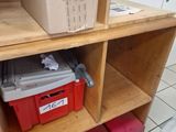 a shelf with boxes and a toolbox on it