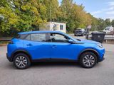 a blue suv parked in a parking lot next to a building