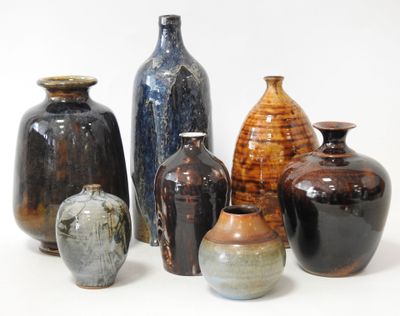 many different vases that are sitting on a white surface