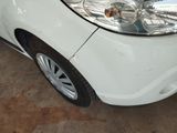 a small white car parked in a garage