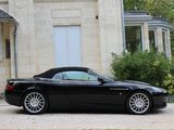 a black sports car parked in front of a house