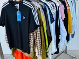 clothes hanging on a rack in a clothing store with a price tag