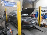 a car that is sitting on a lift in a garage