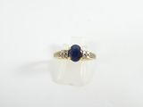 a close up of a ring with a blue stone on it