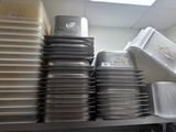 many plates stacked on top of each other in a kitchen