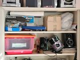 a shelf with many electronics on it in a room