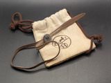 a small bag with a pair of scissors in it