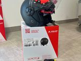 a helmet and a bag on the floor next to a luggage bag