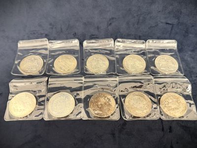 a bunch of gold coins in plastic bags sitting on a table