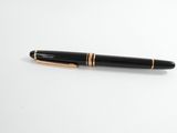a close up of a pen on a white surface with a white background