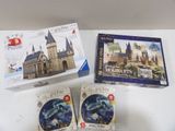 three boxes of puzzles sitting on a table