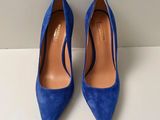 a pair of blue heels on a white surface