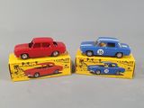 three toy cars are sitting on top of each other on a white surface
