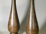 two vases that are sitting next to each other on a table