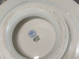 a close up of a white plate with a blue design on it