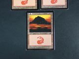 three cards with a picture of a mountain in the background