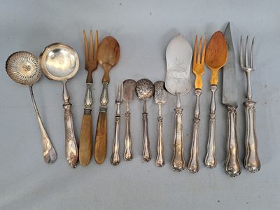 beaucoup d'argenterie sur une table avec des cuillères et des fourchettes