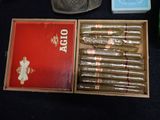 a box of cigars sitting on a table next to other items