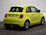 a yellow smart car parked in a room with a checkered floor