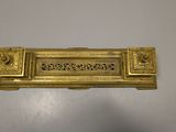 an image of a gold door handle on a white surface
