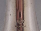 a silver vase with a gold handle on a table