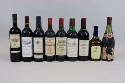 several bottles of wine are lined up in a row on a white surface