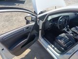 the interior of a car with the door open and the driver ' s seat down