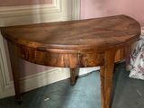 a small table with a wooden top in a room