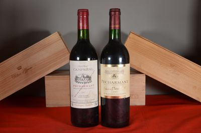 two bottles of wine sitting next to each other on a table