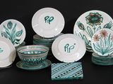 a lot of plates and bowls that are on the table