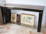 a picture of a black console table with pictures on it