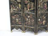 a black room divider with oriental designs on it