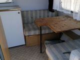a small table and couch in the back of a camper