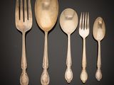 six antique silverware pieces including a fork, spoon, and spoon rest