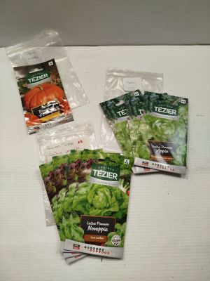 four seed packets of lettuce are sitting on a table