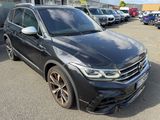 the front of a black volkswagen suv parked in a parking lot