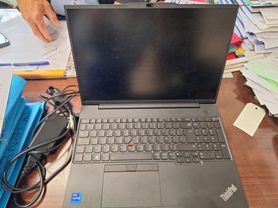 a laptop that is sitting on a desk with papers