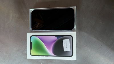 an open box with a black and green phone inside of it