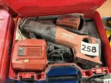a red tool box with tools in it on the floor