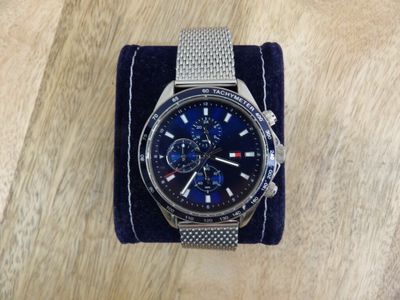 a close up of a watch sitting on a table on a cloth