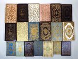 many different types of books are arranged on a white surface