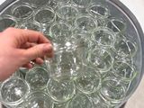 a person that is holding a jar of water in a bowl