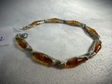 a close up of a bracelet on a table with a price tag