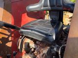 a red truck with a black seat and steering wheel