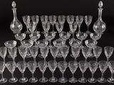 an assortment of wine glasses and decanters on a black background