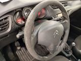 dashboard of a small car with a steering wheel and dashboard controls