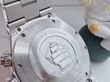 a watch that is sitting on a table next to a figurine