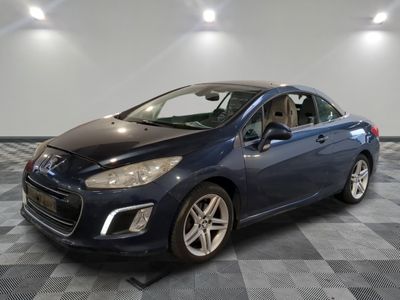 a blue car is parked on a checkered floor in a garage