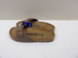 a close up of a pair of sandals on a white surface