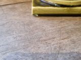 a green vase sitting on top of a wooden table